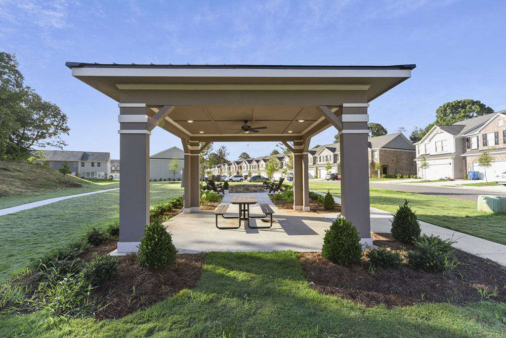 a pavilion with a picnic table in a park