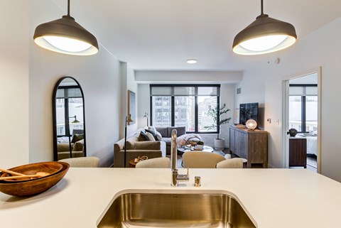 A modern kitchen with a large sink and a bowl on the counter.