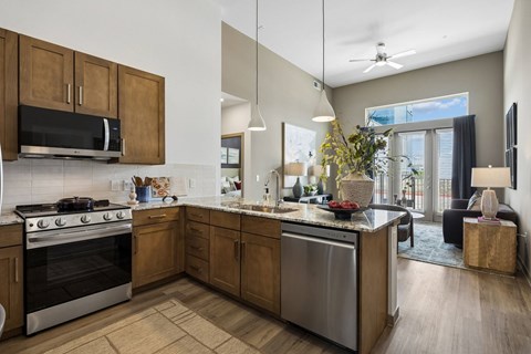 A modern kitchen with wooden cabinets and stainless steel appliances.