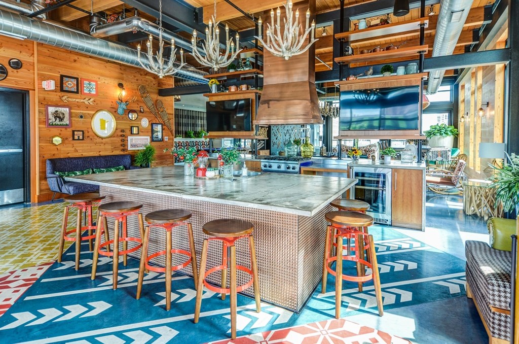 a large kitchen with a large island with stools in front of it