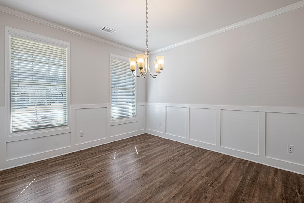 a living room with white walls and wood floors