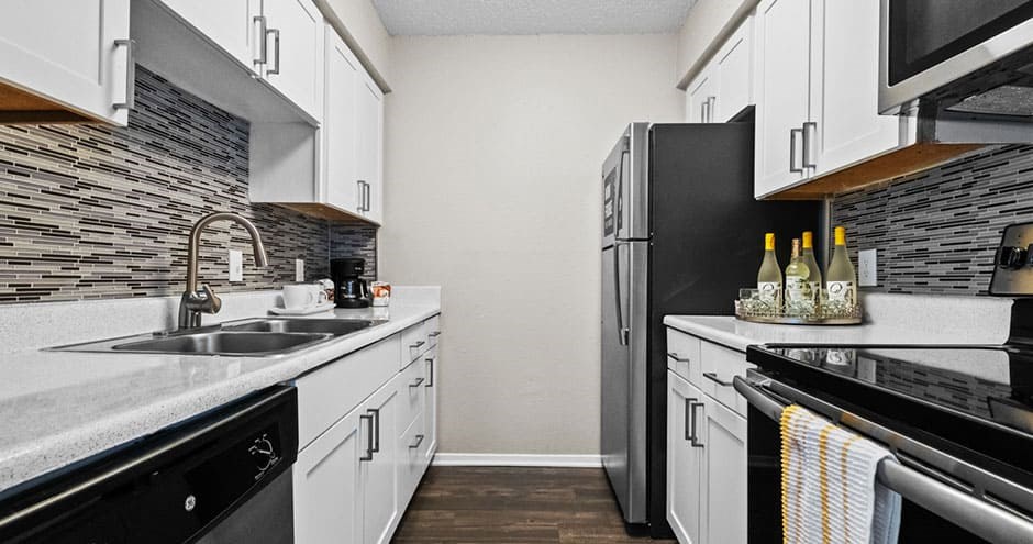 a kitchen with a sink and a refrigerator
