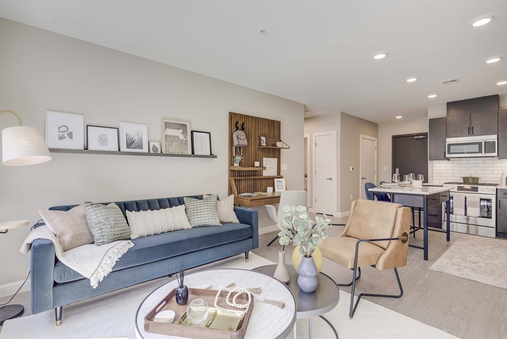 A modern living room with a blue couch and a coffee table.