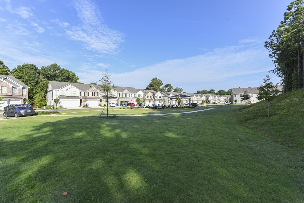 a view of a yard with houses in the background