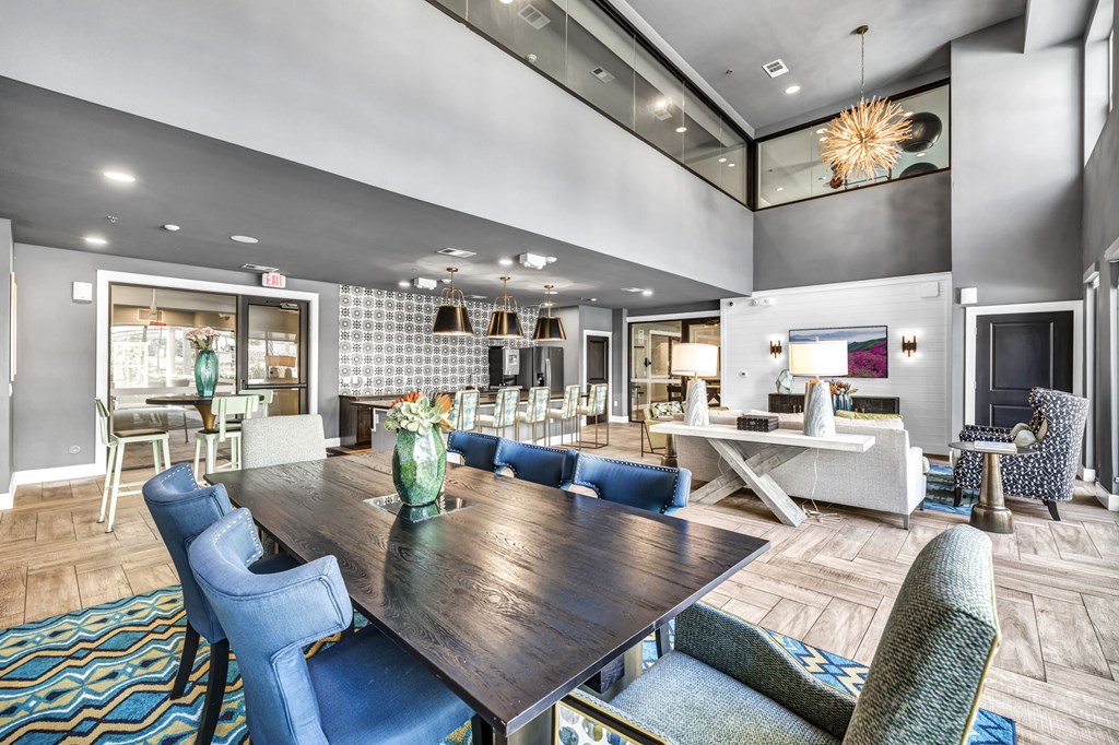 a clubhouse with a dining room table and chairs