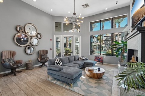 A living room with a grey couch and a fireplace.
