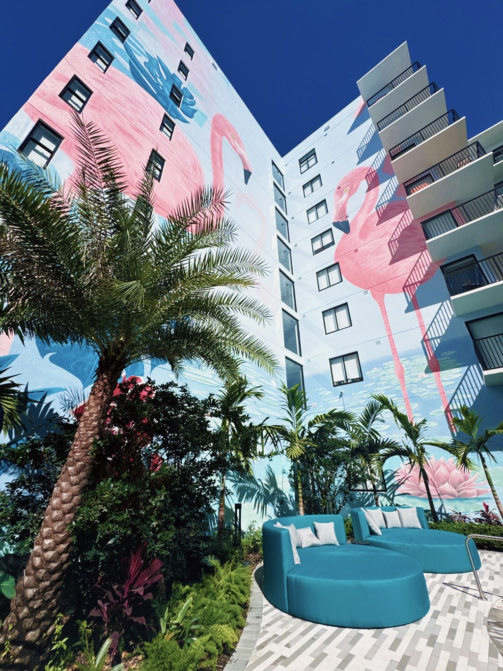 A building with a mural of a pink flamingo on it.