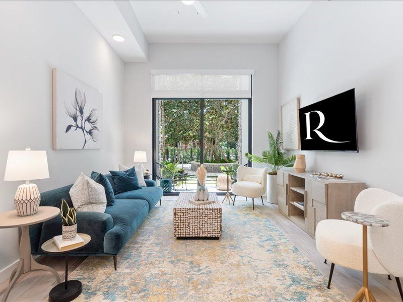 a living room with a blue couch and a large window