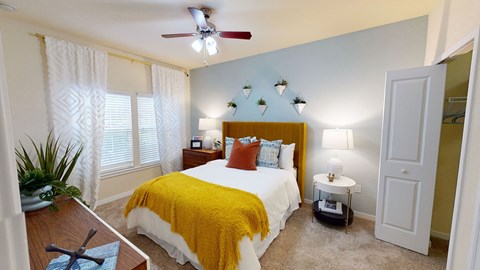 a bedroom with a bed and a ceiling fan