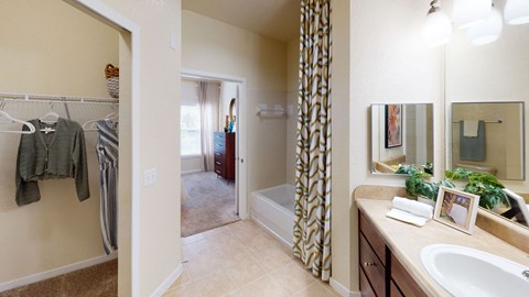 a bathroom with a shower and a sink and a mirror
