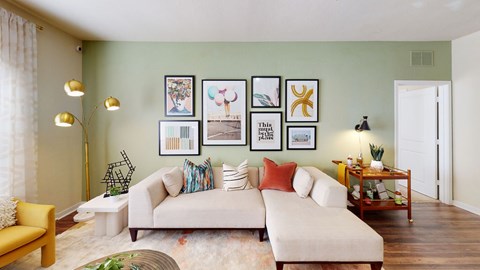 a living room with a couch and pictures on the wall