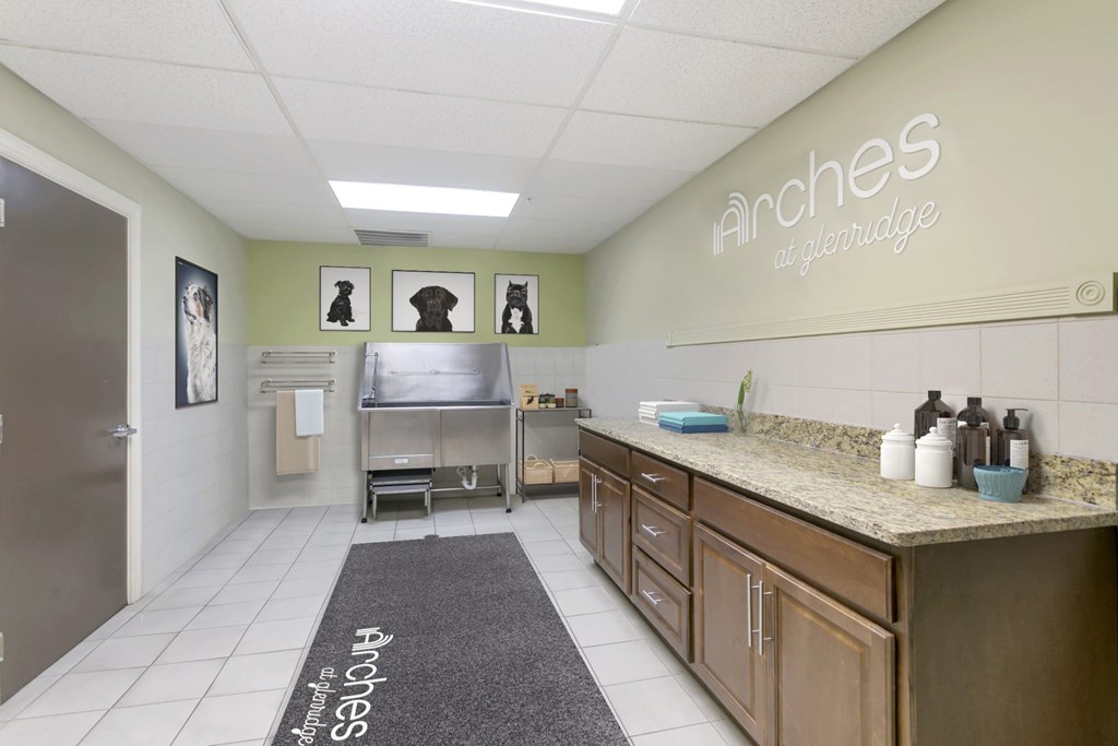 a laundry room with a sink and a ironing board