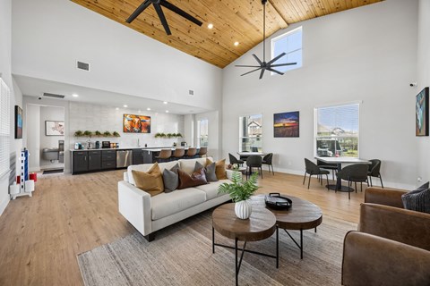 A living room with a white couch and a wooden coffee table.