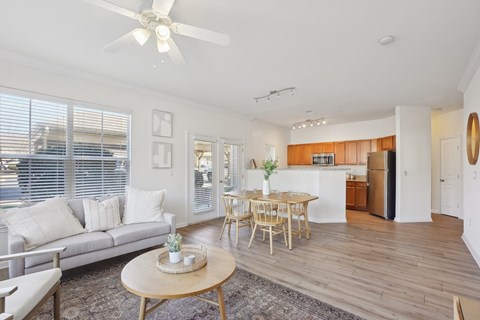 A living room with a grey couch and a wooden table.