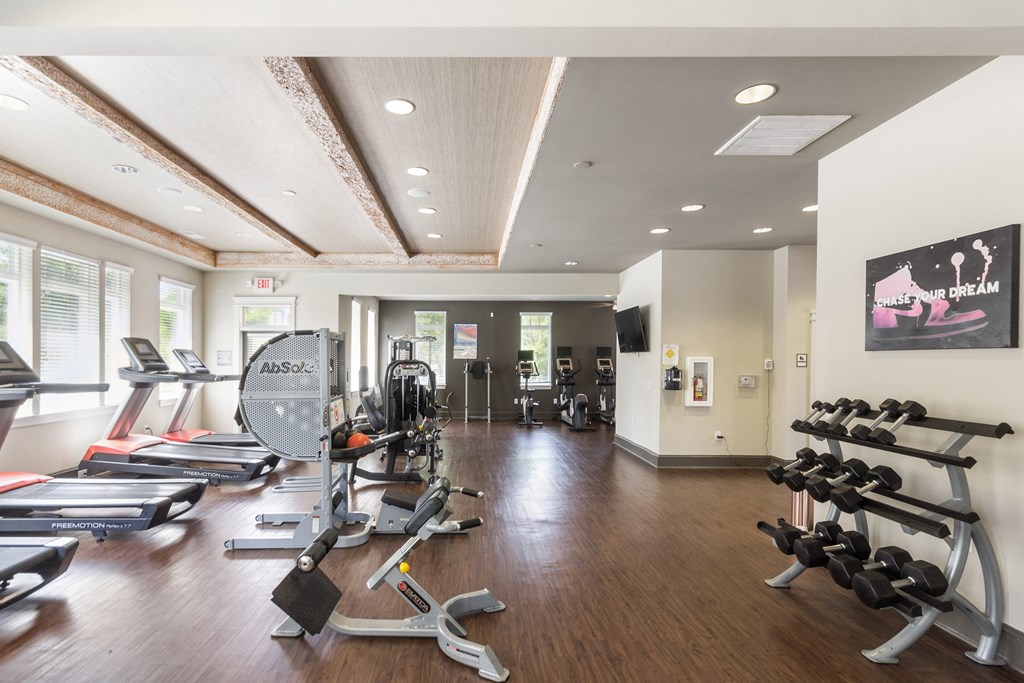 a spacious fitness center with treadmills and other exercise equipment