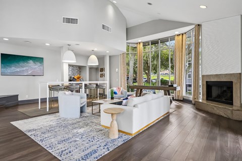 A modern living room with a fireplace and a large painting on the wall.