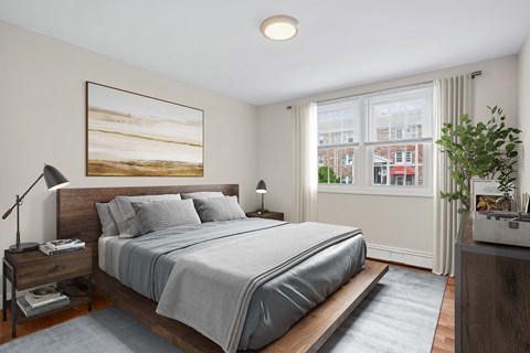 A bedroom with a large bed and a painting on the wall.