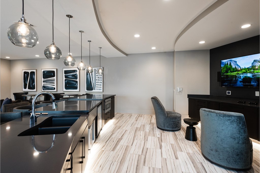 a large kitchen with a large counter top and a tv