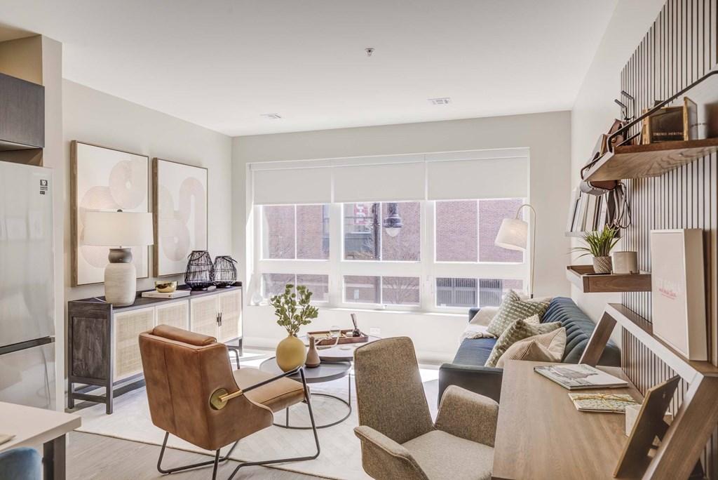 A living room with a brown chair and a grey couch.