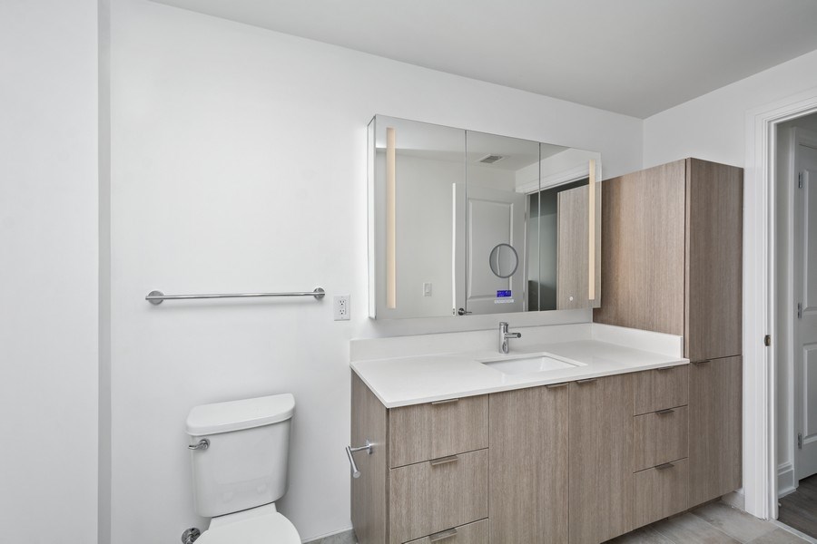 a bathroom with a toilet and a sink and a mirror