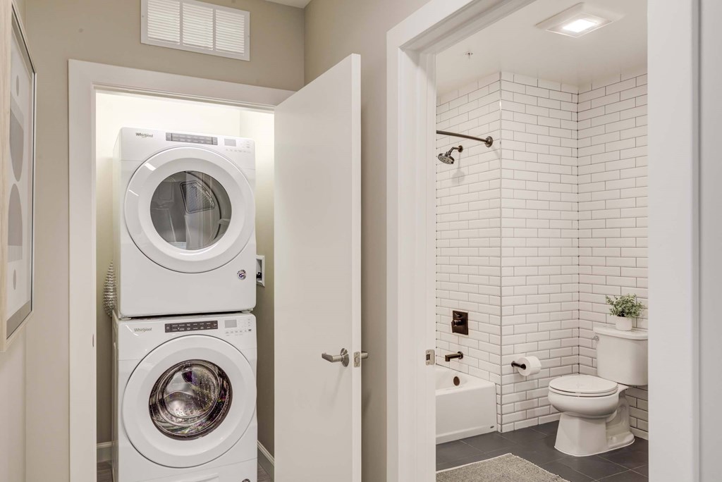 A white washing machine and dryer in a small laundry room.