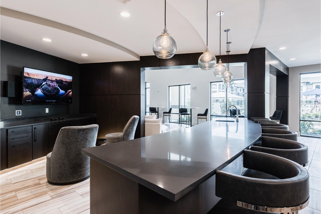 a large dining room with a long table and chairs and a tv
