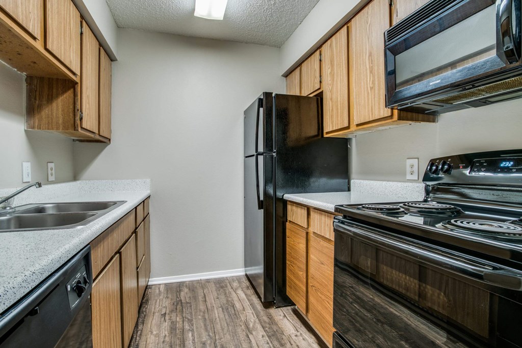 the kitchen of a home with a stove refrigerator and sink