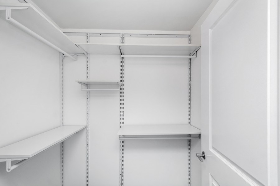 the inside of an empty refrigerator with the door open