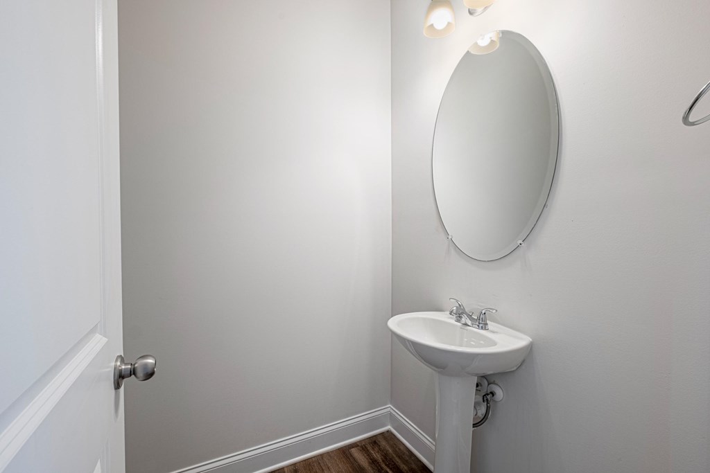 a small bathroom with a sink and a mirror