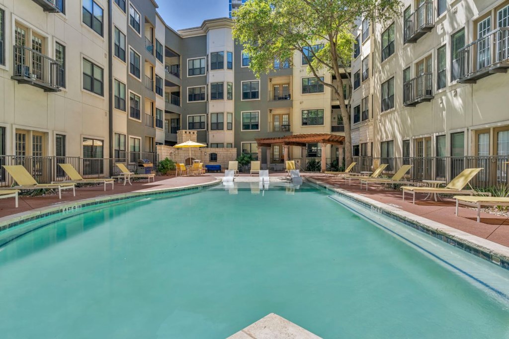 a swimming pool in front of an apartment building