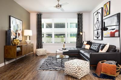 Parkside at Round Rock Living Room Interior with Wood Style Floor and Ceiling Fan