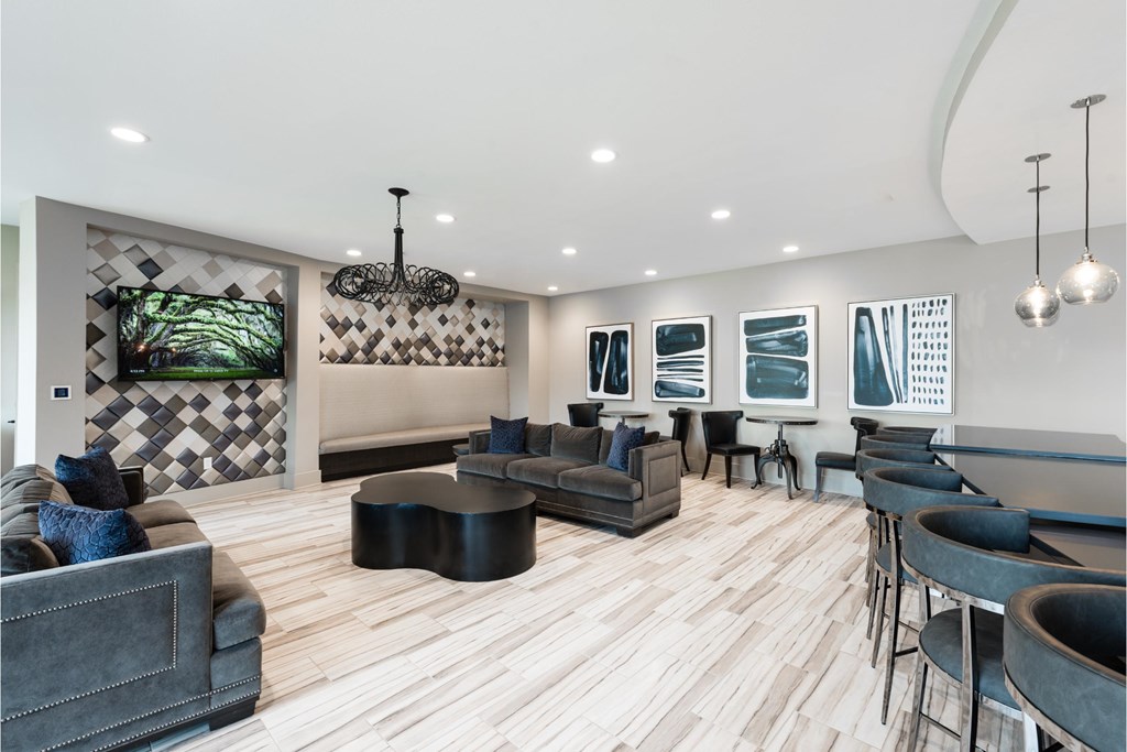 a lounge area with couches chairs and tables and a bar