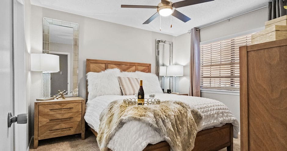 a bedroom with a bed and a ceiling fan