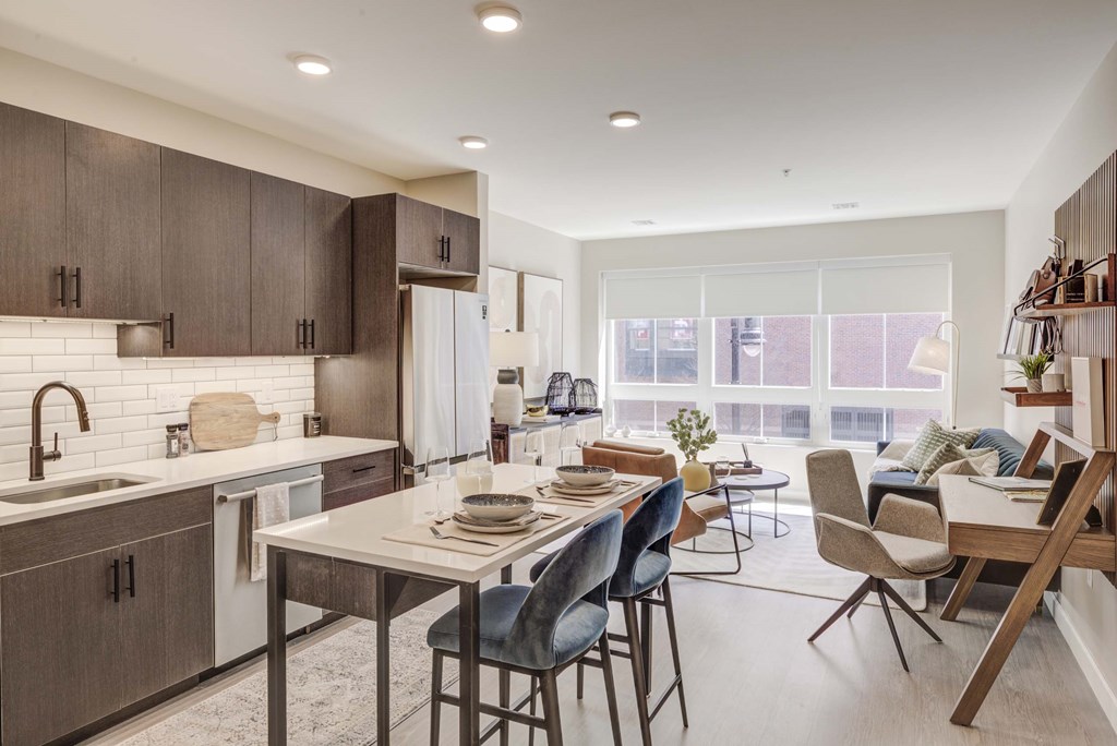 A modern kitchen with a dining table and chairs.