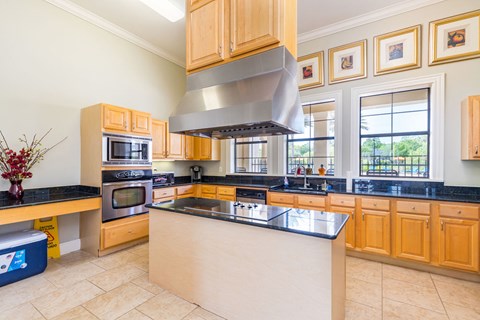 A kitchen with wooden cabinets and a large island.