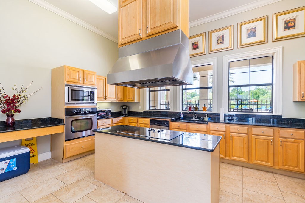 A kitchen with wooden cabinets and a large island.