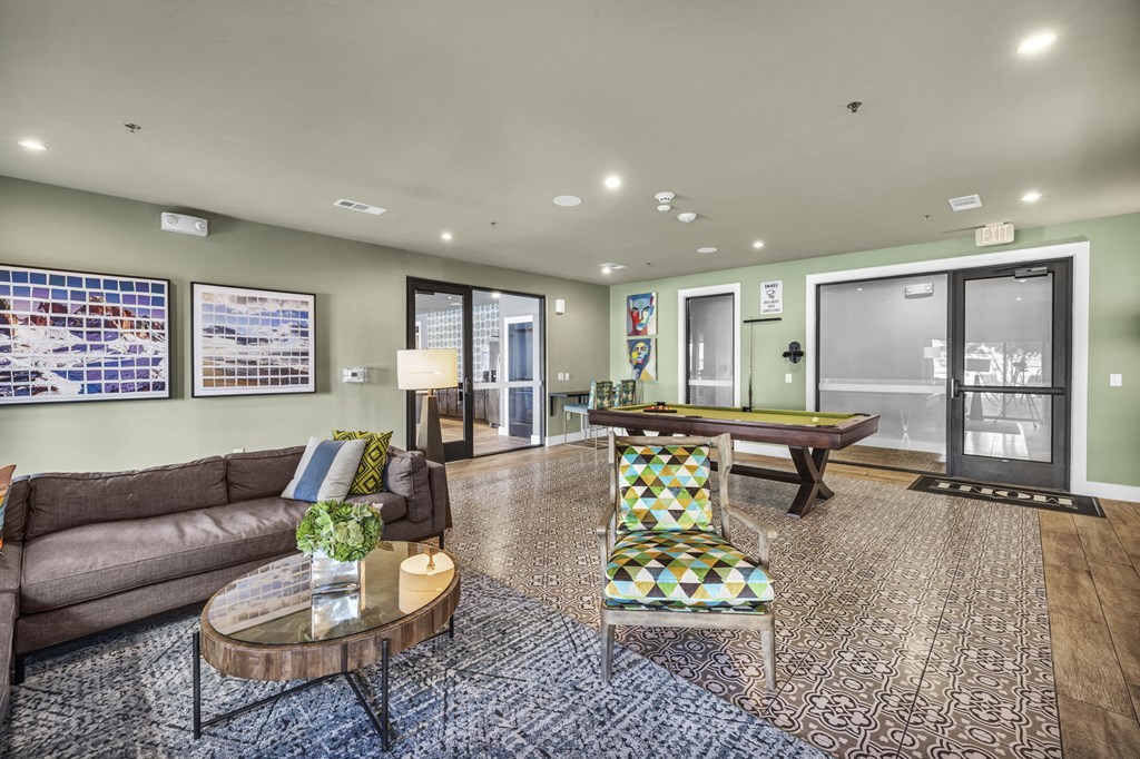 a game room with a pool table and a couch