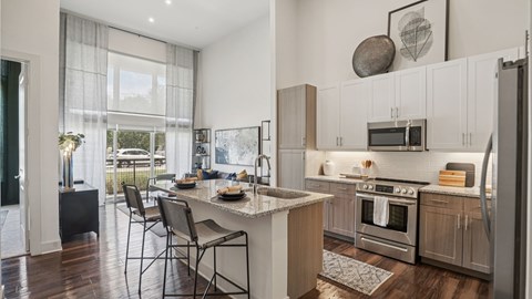 A modern kitchen with a dining table and chairs.