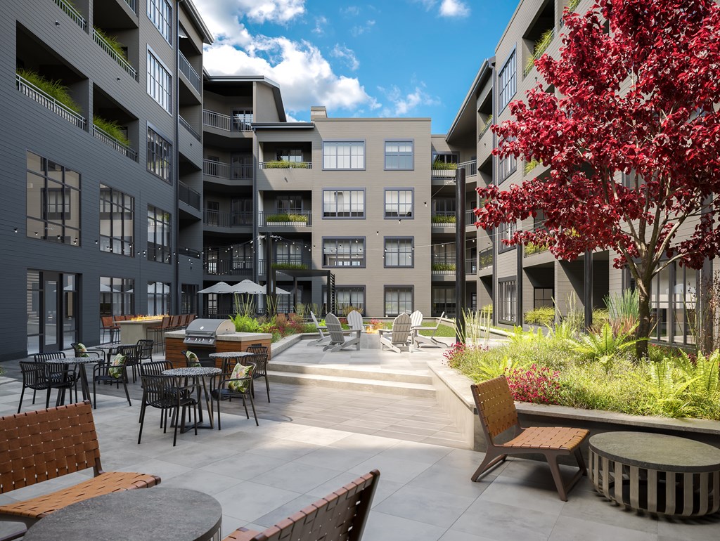 Luxury Studio Apartments Westfield, IN - The Union at Grand Junction - Outdoor Courtyard with Tables, Chairs, Gas Fire Pits, and Grills.