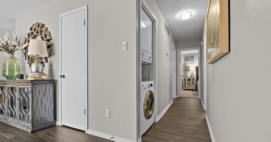 a white hallway with a washing machine and a dryer