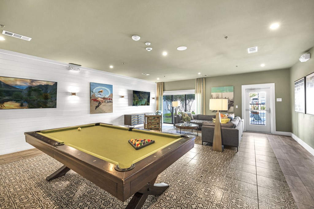 play a game of pool in the clubhouse at the estates run apartments