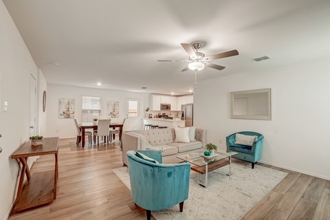 Well-decorated living room and dining area, bathed in ample natural light, creating an inviting and aesthetically pleasing atmosphere