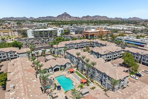 A large complex with a pool in the middle.