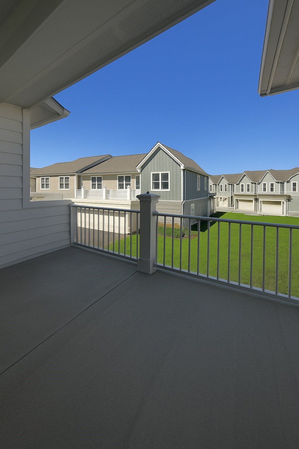 A balcony with a view of a residential area.