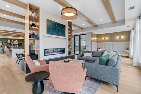 A modern living room with a fireplace and a painting on the wall.