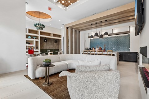 A modern living room with a white sofa and a wooden coffee table.