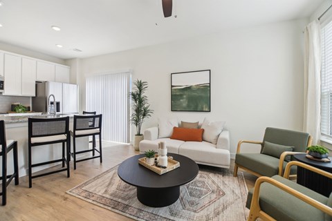 A living room with a black coffee table and a white couch.