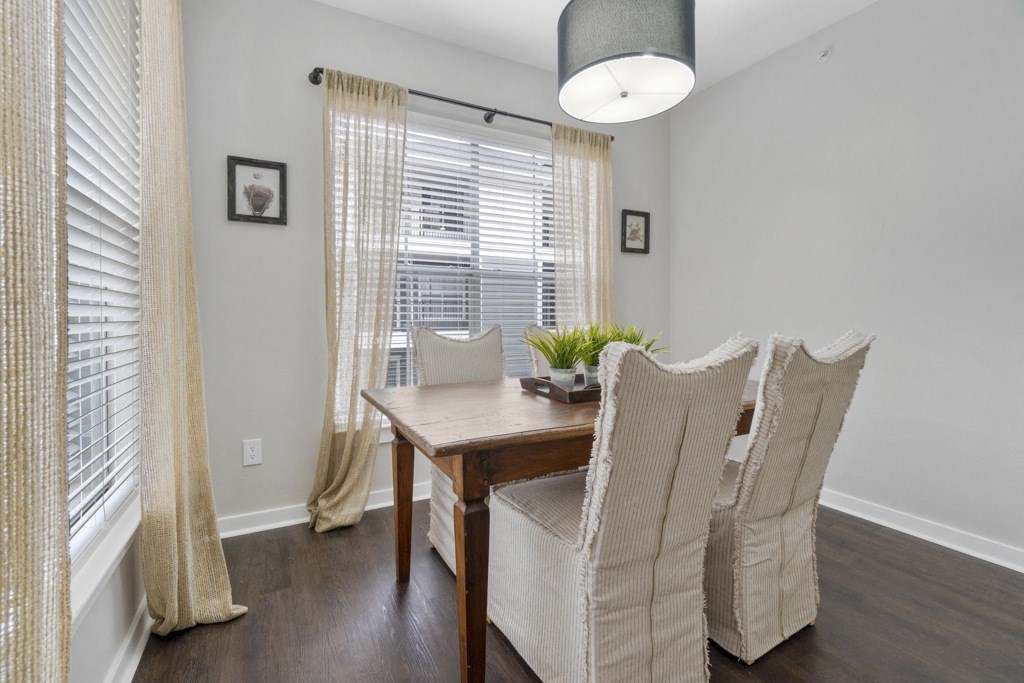 Dining Room with hardwood style flooring and large window