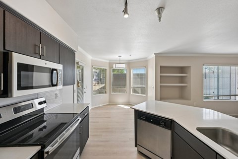 A modern kitchen with a black stove top oven and a microwave above it.