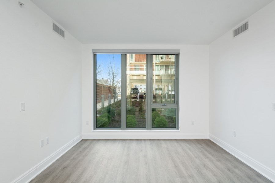 an empty living room with a large window